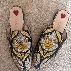 Gucci Women's Black and Gold Patterned Mules